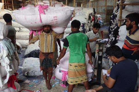 Loading a truck for shipment of production waste in Bangladesh